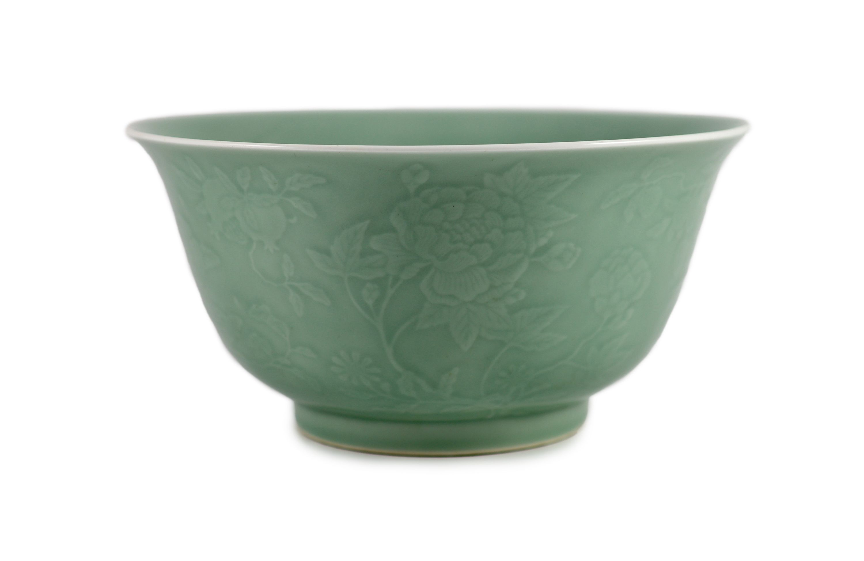 A fine large Chinese moulded celadon-glazed bowl, Qianlong seal mark and of the period (1736-95), Rim 33.6mm diameter, 16.5cm high, foot 16cm diameter